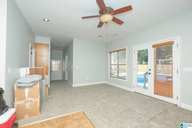 carpeted spare room with ceiling fan