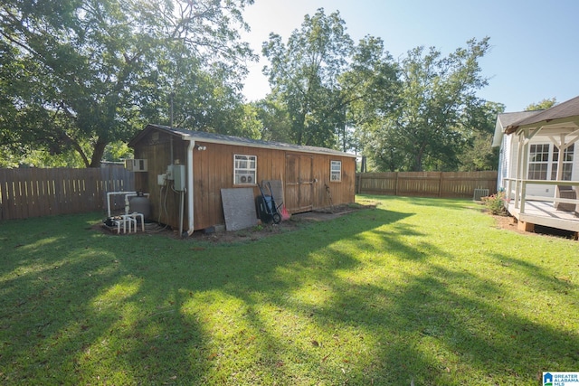 view of yard featuring a deck and an outbuilding