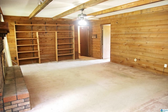 bonus room with ceiling fan, beamed ceiling, and wood walls