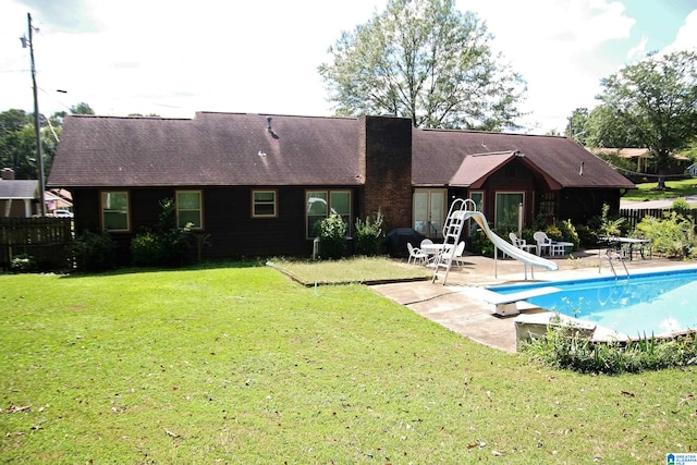 rear view of house with a lawn and a patio area