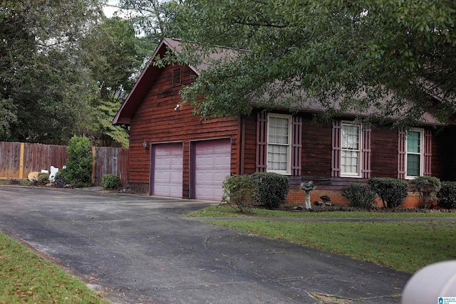 exterior space featuring a yard and a garage