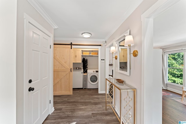 corridor featuring crown molding, a barn door, dark hardwood / wood-style flooring, and washer / dryer