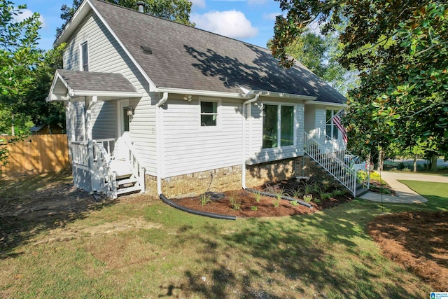 back of house with a lawn