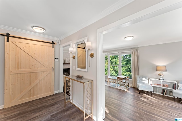 entryway featuring a barn door, crown molding, and dark wood-type flooring