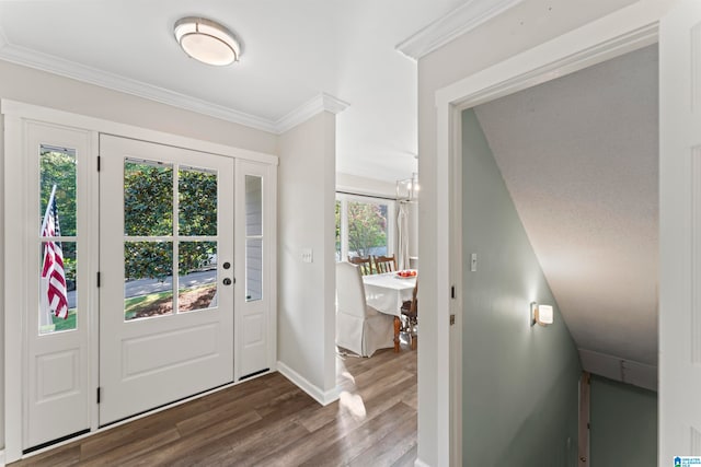 entrance foyer with ornamental molding, a wealth of natural light, and hardwood / wood-style flooring