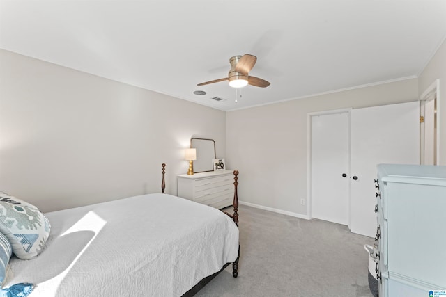 bedroom with ornamental molding, ceiling fan, and light colored carpet