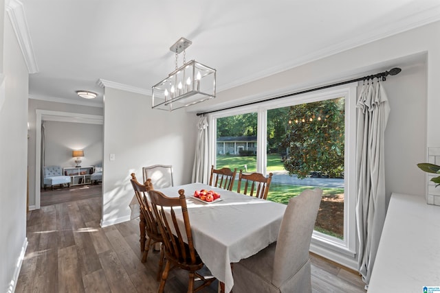 dining space featuring crown molding and dark hardwood / wood-style floors