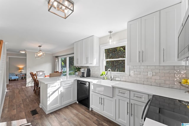 kitchen featuring black dishwasher, dark hardwood / wood-style flooring, pendant lighting, and kitchen peninsula