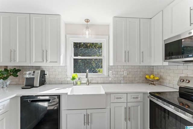 kitchen featuring decorative backsplash, white cabinetry, appliances with stainless steel finishes, and pendant lighting