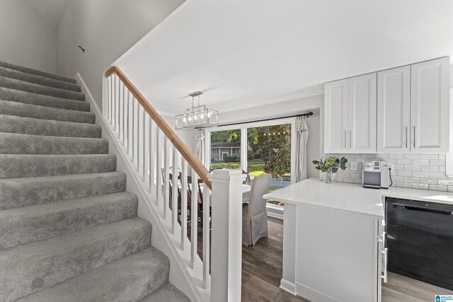2825 Cahawba Trl, Birmingham, AL 35243 - staircase with a notable chandelier, beverage cooler, and wood finished floors