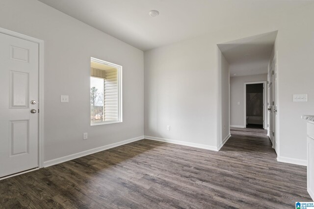 unfurnished room featuring dark hardwood / wood-style floors