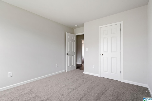 unfurnished bedroom with carpet floors and a closet