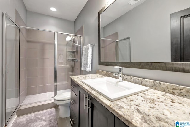 bathroom with tile patterned flooring, vanity, toilet, and an enclosed shower