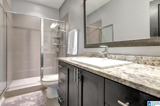 bathroom featuring vanity, toilet, tile patterned floors, and a shower with shower door