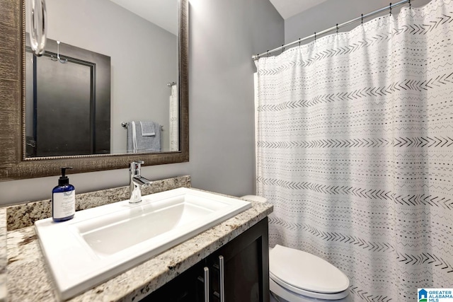 bathroom with vanity, toilet, and a shower with curtain