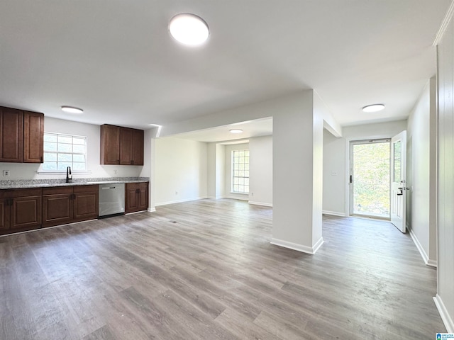 kitchen featuring dark brown cabinets, dishwasher, light hardwood / wood-style flooring, and sink