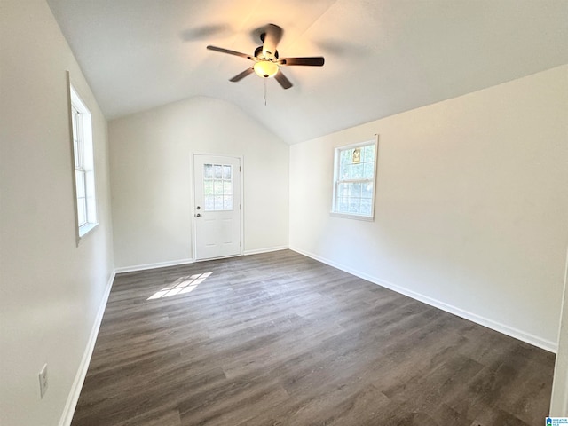 spare room with lofted ceiling, dark hardwood / wood-style flooring, and ceiling fan