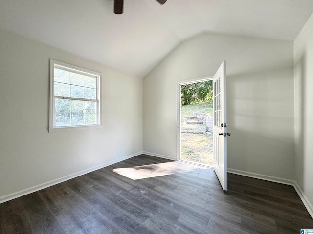 empty room featuring ceiling fan, vaulted ceiling, and dark hardwood / wood-style flooring