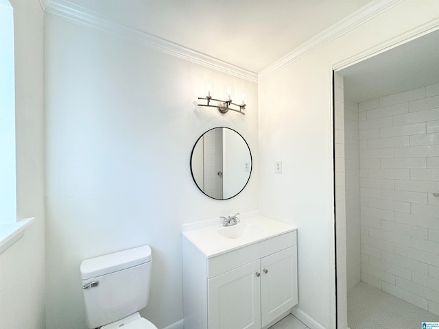 bathroom featuring a tile shower, vanity, crown molding, and toilet