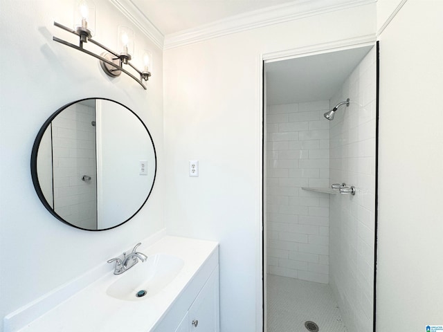 bathroom with ornamental molding, vanity, and a tile shower