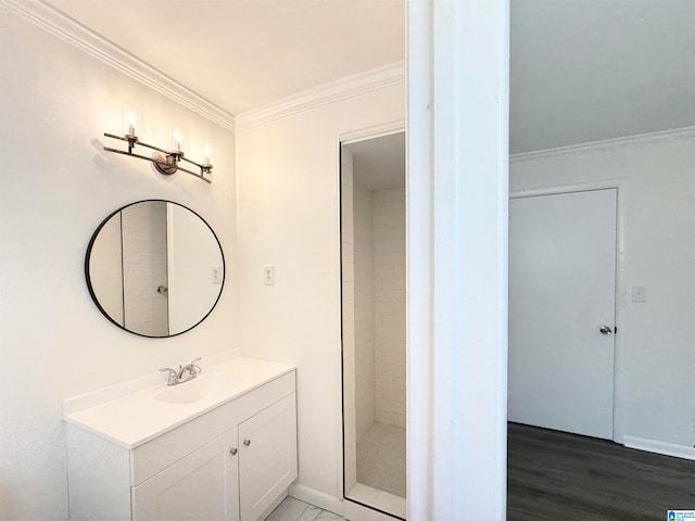 bathroom featuring walk in shower, hardwood / wood-style flooring, vanity, and crown molding