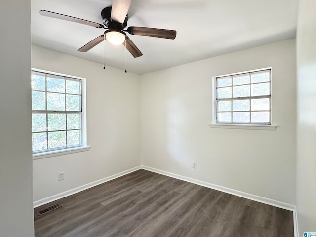 unfurnished room with dark wood-type flooring and ceiling fan