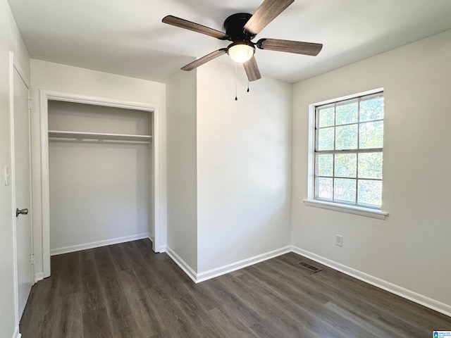 unfurnished bedroom featuring a closet, ceiling fan, and dark hardwood / wood-style flooring