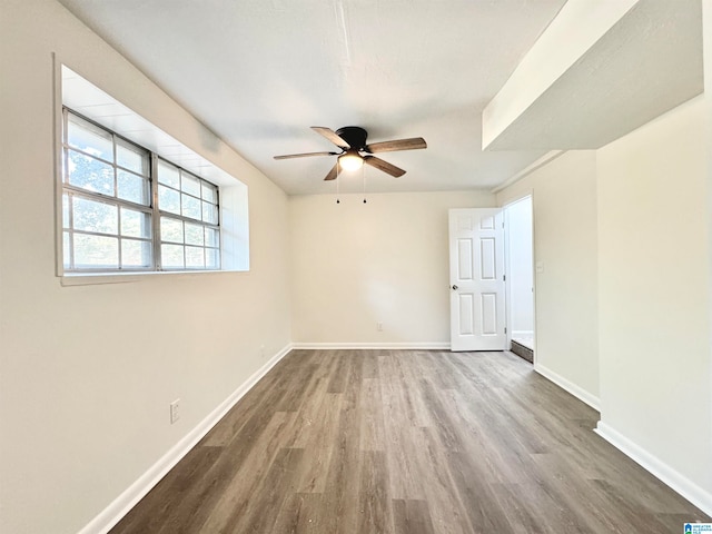 spare room featuring wood-type flooring and ceiling fan