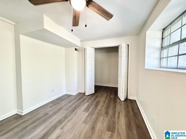 unfurnished bedroom featuring ceiling fan, a closet, and dark hardwood / wood-style floors