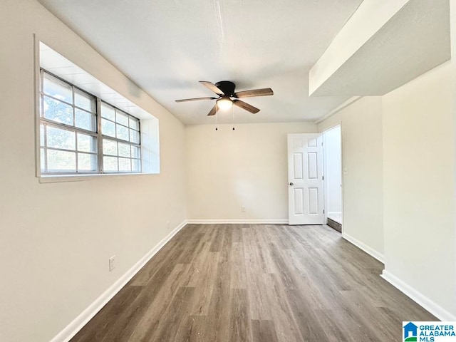 spare room with ceiling fan and hardwood / wood-style flooring