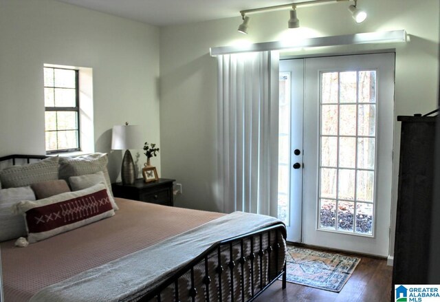 bedroom with dark wood-type flooring and rail lighting