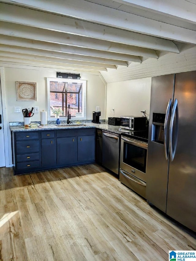 kitchen with light hardwood / wood-style floors, beamed ceiling, blue cabinetry, stainless steel appliances, and sink