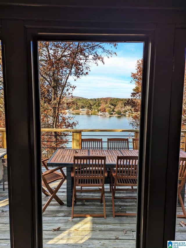 wooden terrace featuring a water view