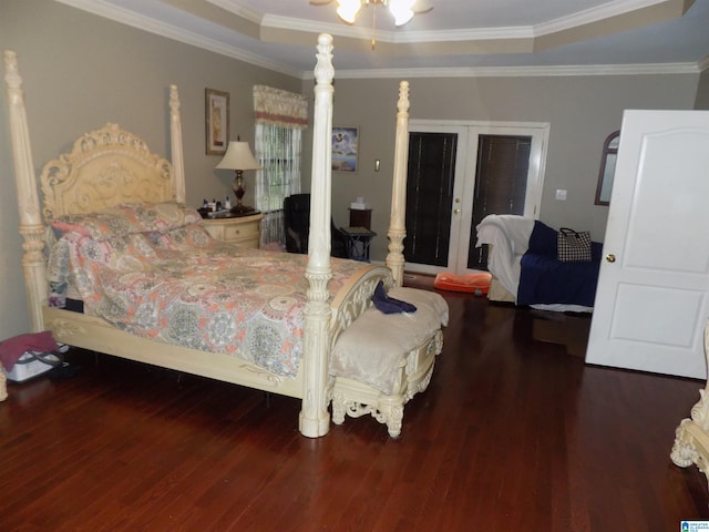 bedroom featuring a raised ceiling, crown molding, and dark wood-type flooring