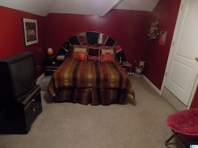 carpeted bedroom with lofted ceiling