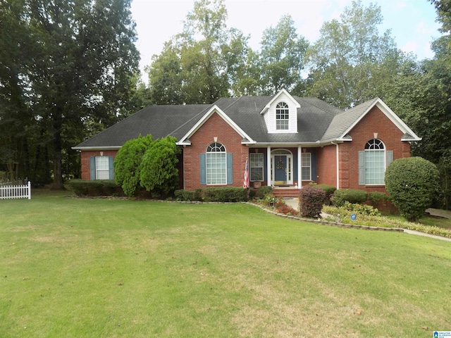 cape cod home featuring a front lawn