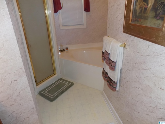 bathroom featuring shower with separate bathtub and tile patterned flooring