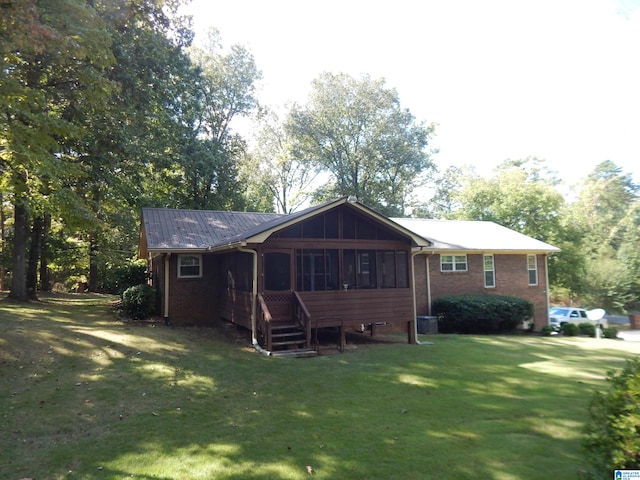 rear view of property with a yard