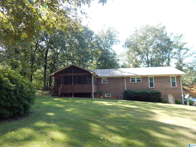 view of front facade with a front lawn and a sunroom