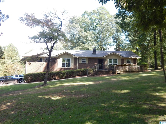 ranch-style house with a front yard and a wooden deck