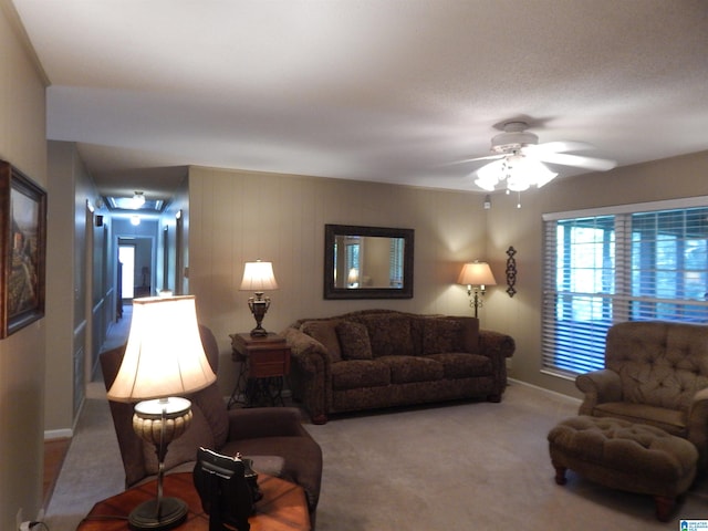 carpeted living room with ceiling fan