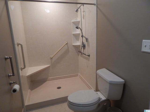 bathroom with a shower and toilet