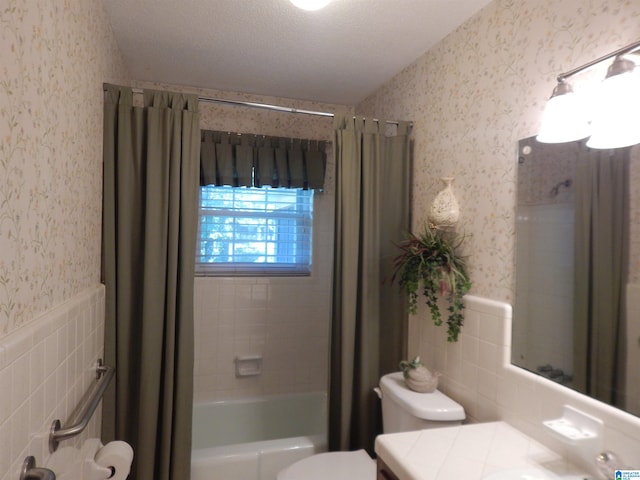 full bathroom featuring shower / tub combo, a textured ceiling, vanity, and toilet