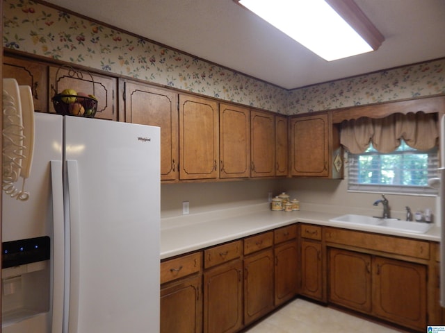 kitchen with white fridge with ice dispenser and sink