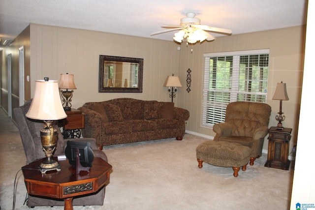 carpeted living room with ceiling fan and a textured ceiling