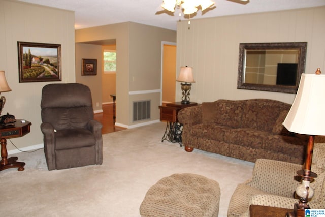 carpeted living room with ceiling fan