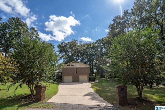 view of front of home with a front yard and a garage