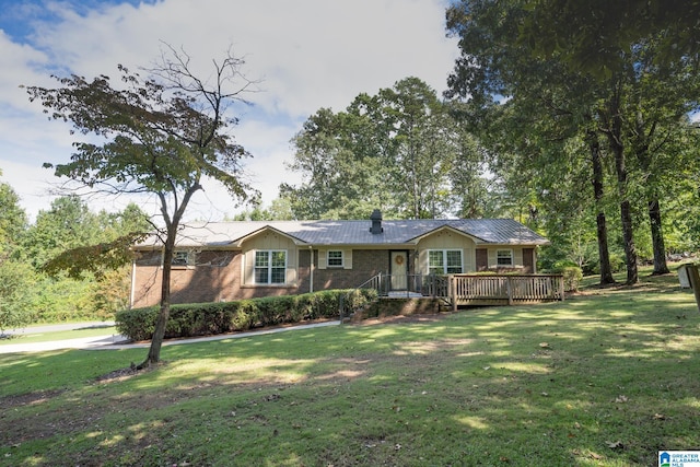 single story home featuring a front yard and a wooden deck