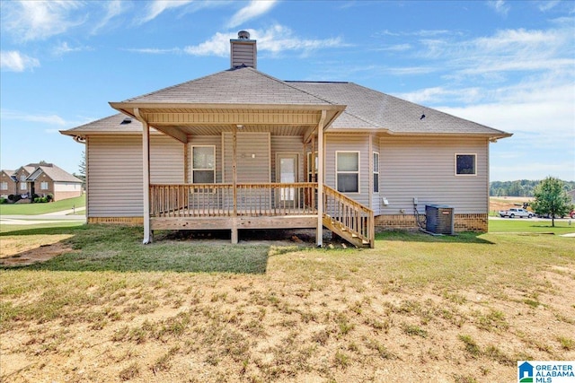 rear view of property with cooling unit, a yard, and a porch