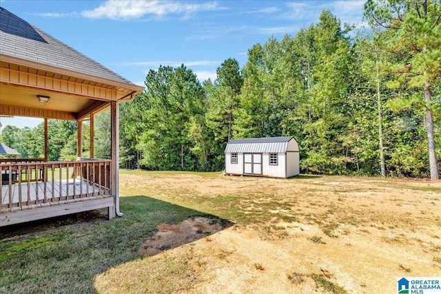 view of yard featuring a shed and a deck